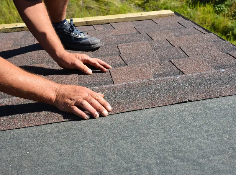 Roofing contractor replacing shingles on a home in Charlotte, NC
