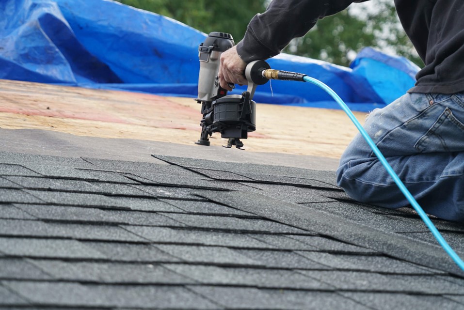 A roofing professional working on a residential roof in Charlotte, NC