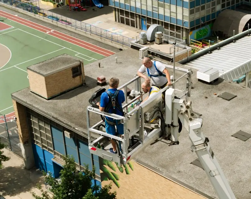 Crew repairing commercial flat roof in Charlotte, NC